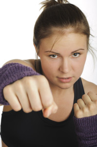 Young attractive woman showing boxing motion